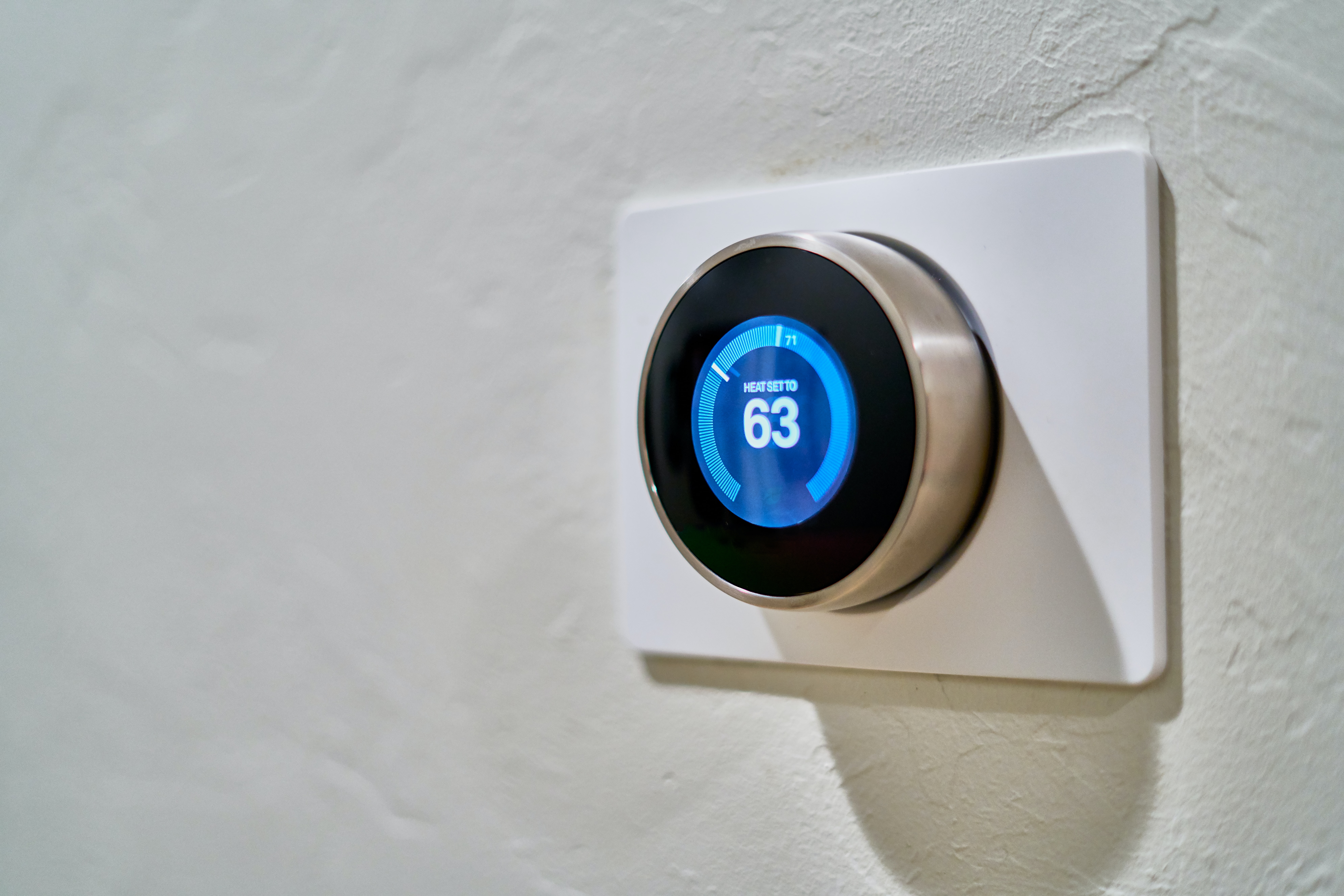 A smart thermostat on a wall
